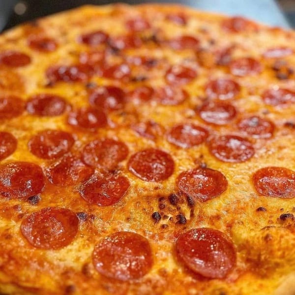 Close-up of a freshly baked pepperoni pizza from Terra Ristorante & Bar, with melted cheese and crispy crust.